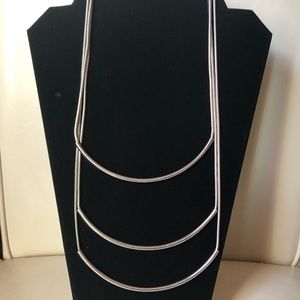 Silver tone necklace .